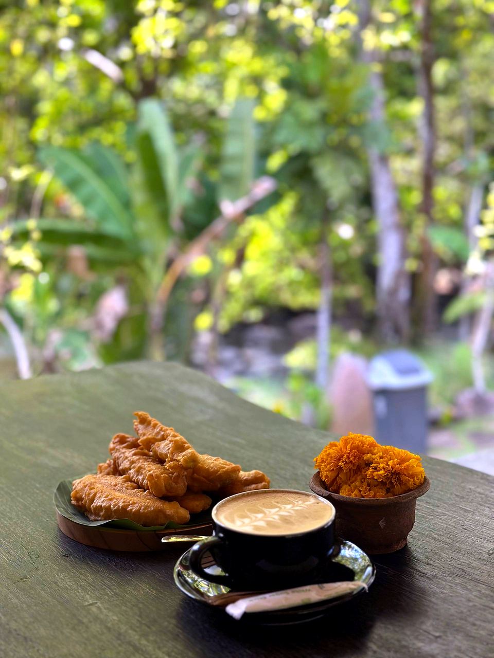 Coffee and Balinese snacks at a table in the garden