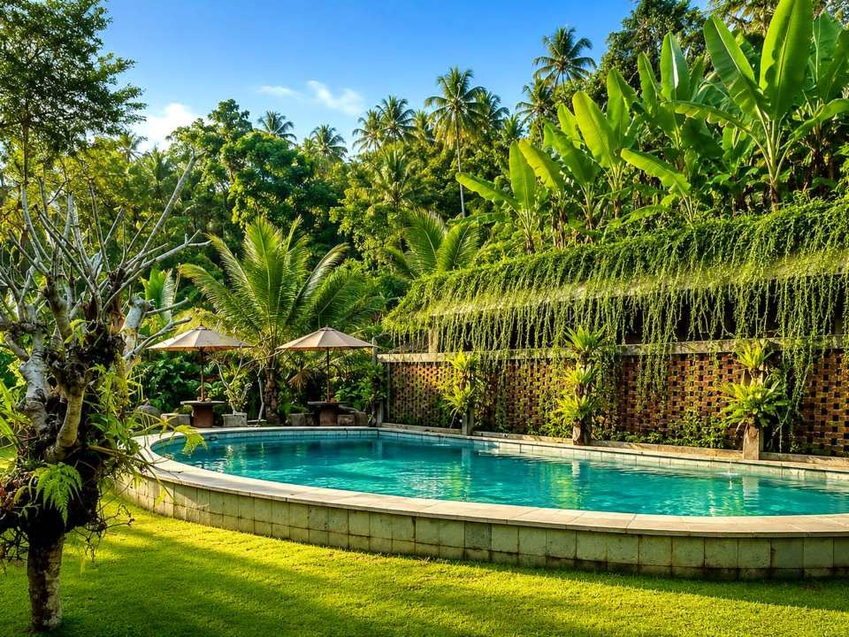 Swimming pool surrounded by tropical garden at Sari Gumitir, Tabanan, Bali